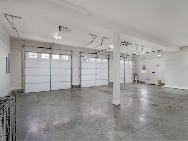 garage featuring electric panel, a garage door opener, and a carport