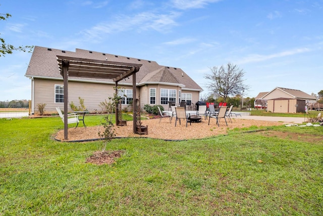 rear view of property featuring a pergola, a patio, and a lawn