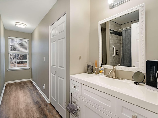 bathroom with vanity, hardwood / wood-style flooring, and curtained shower