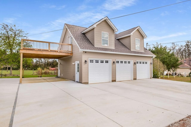 view of side of property featuring a deck and a garage