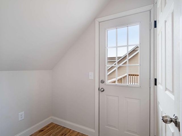 entryway with wood-type flooring and lofted ceiling