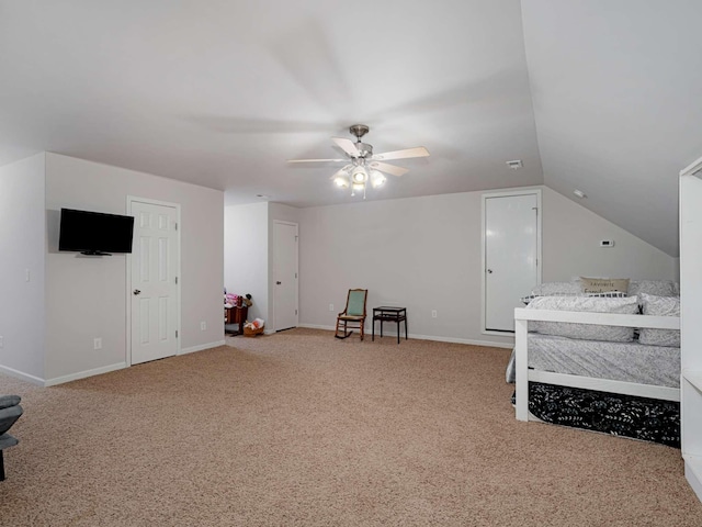 carpeted bedroom with ceiling fan and vaulted ceiling