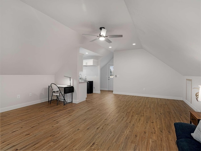 additional living space featuring hardwood / wood-style flooring, ceiling fan, lofted ceiling, and sink