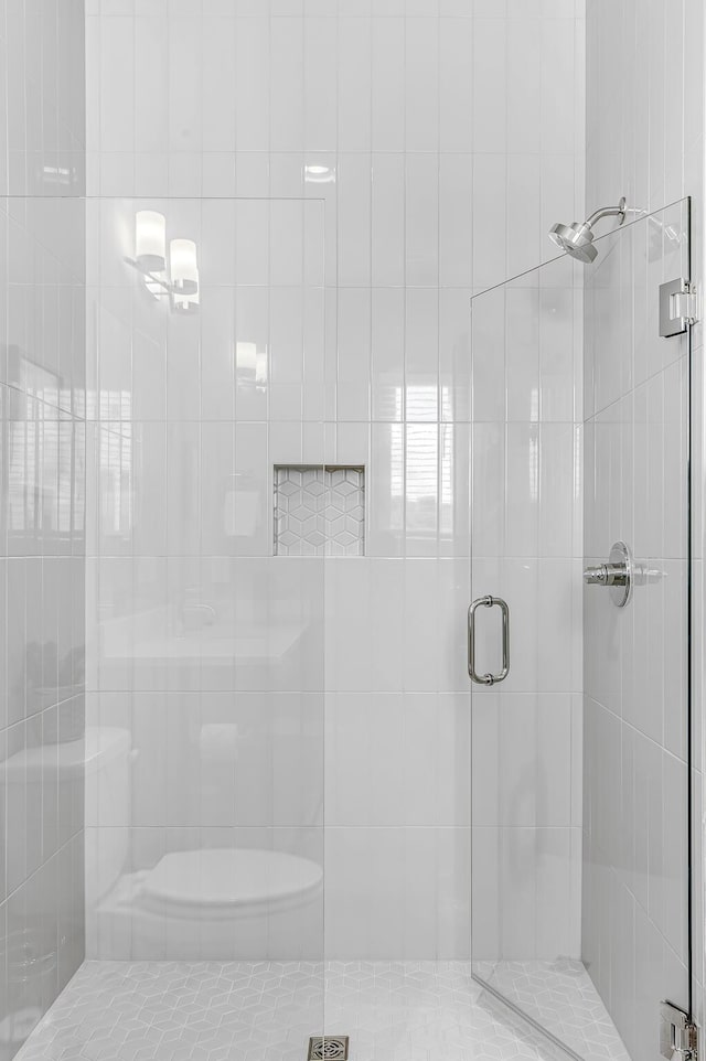 bathroom featuring a shower with shower door