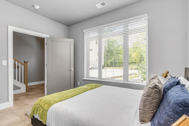 bedroom featuring light tile patterned floors