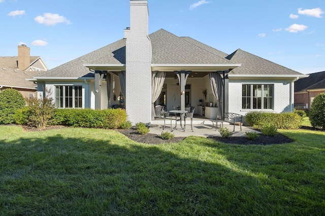 back of house with a yard and a patio area