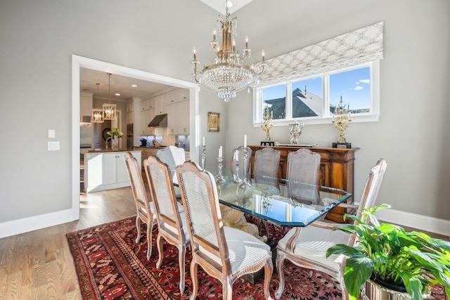 dining space featuring wood-type flooring and a notable chandelier