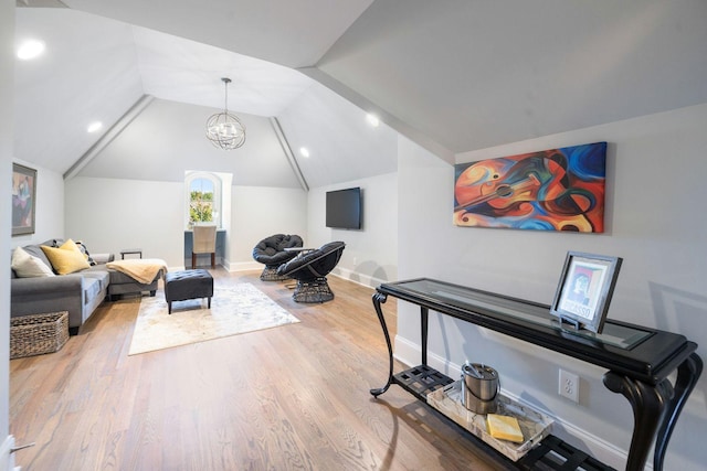 interior space with hardwood / wood-style floors, a chandelier, and vaulted ceiling