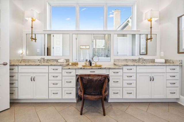 bathroom featuring tile patterned flooring and vanity