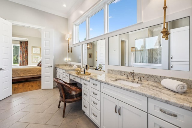 bathroom with tile patterned floors, plenty of natural light, and vanity