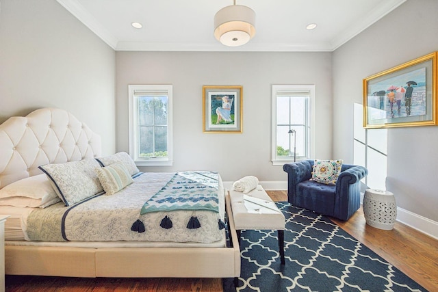 bedroom with hardwood / wood-style floors and crown molding