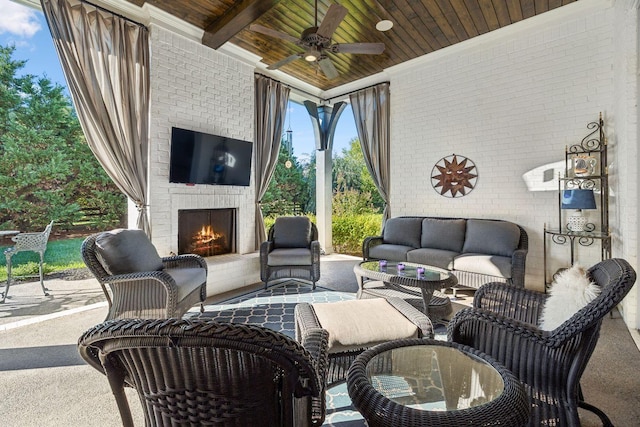 view of patio / terrace featuring an outdoor living space with a fireplace and ceiling fan