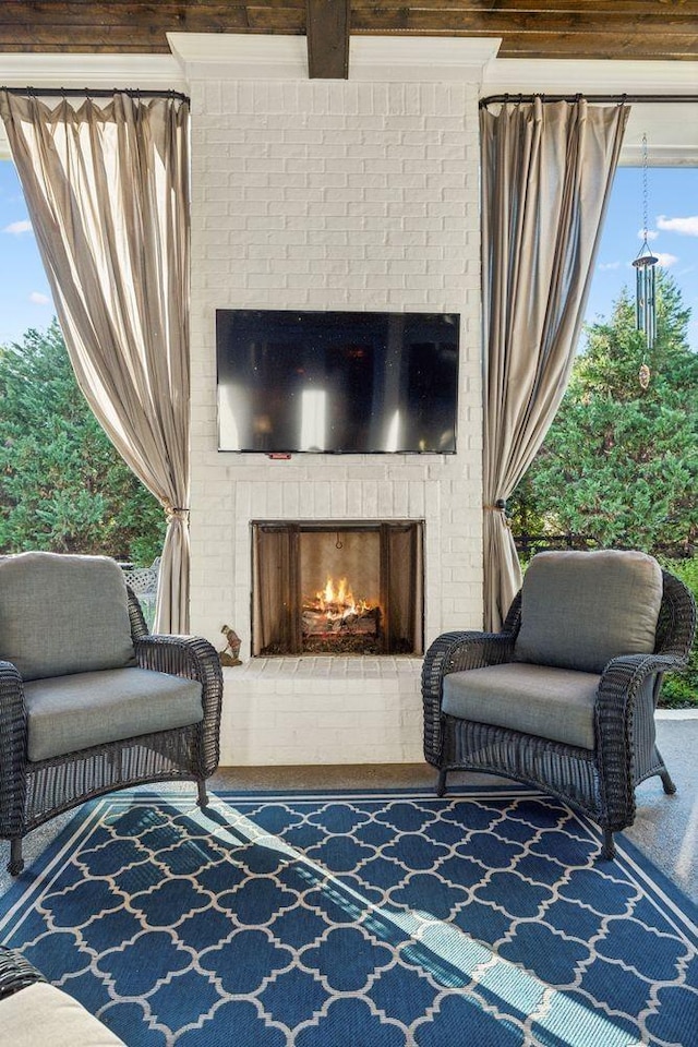 view of patio with an outdoor brick fireplace