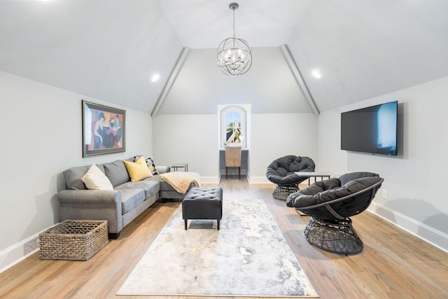 living room featuring a chandelier, vaulted ceiling, and light wood-type flooring