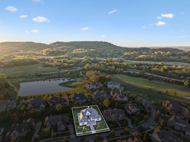 birds eye view of property with a water and mountain view