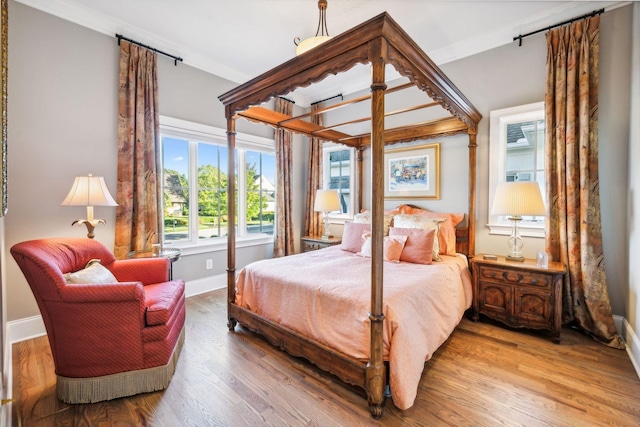 bedroom featuring hardwood / wood-style flooring and ornamental molding