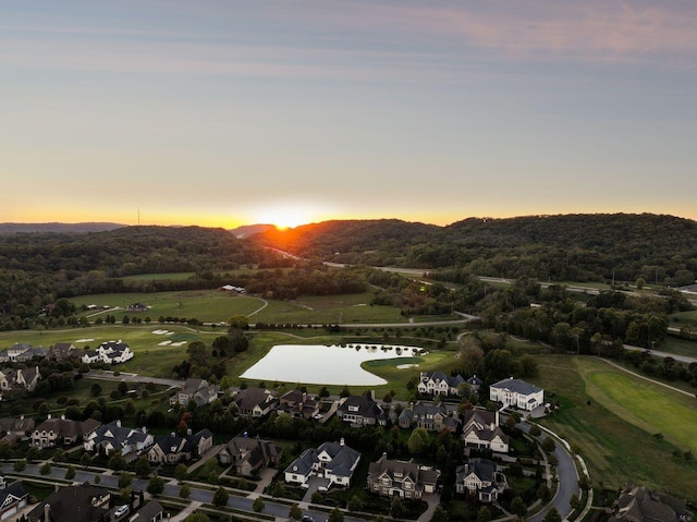 aerial view at dusk with a water view