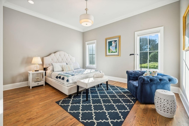 bedroom featuring wood-type flooring and crown molding