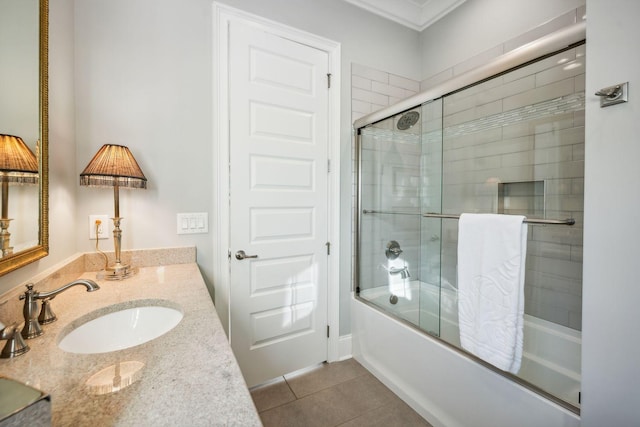 bathroom with tile patterned floors, vanity, enclosed tub / shower combo, and ornamental molding