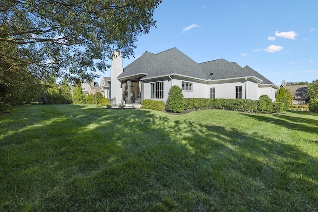 back of house featuring a yard