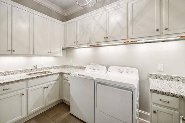 washroom with cabinets, tile patterned floors, crown molding, sink, and separate washer and dryer