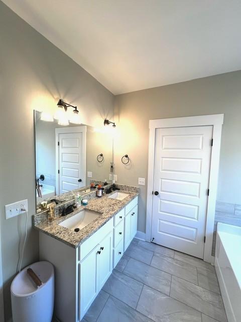 bathroom featuring a washtub and vanity