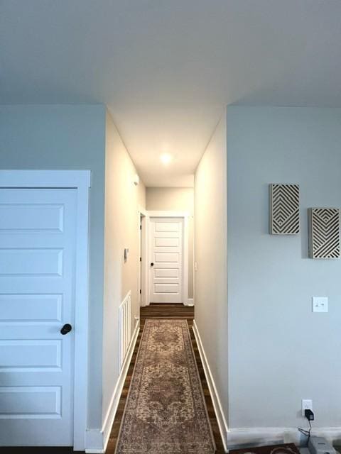 hallway with dark hardwood / wood-style floors