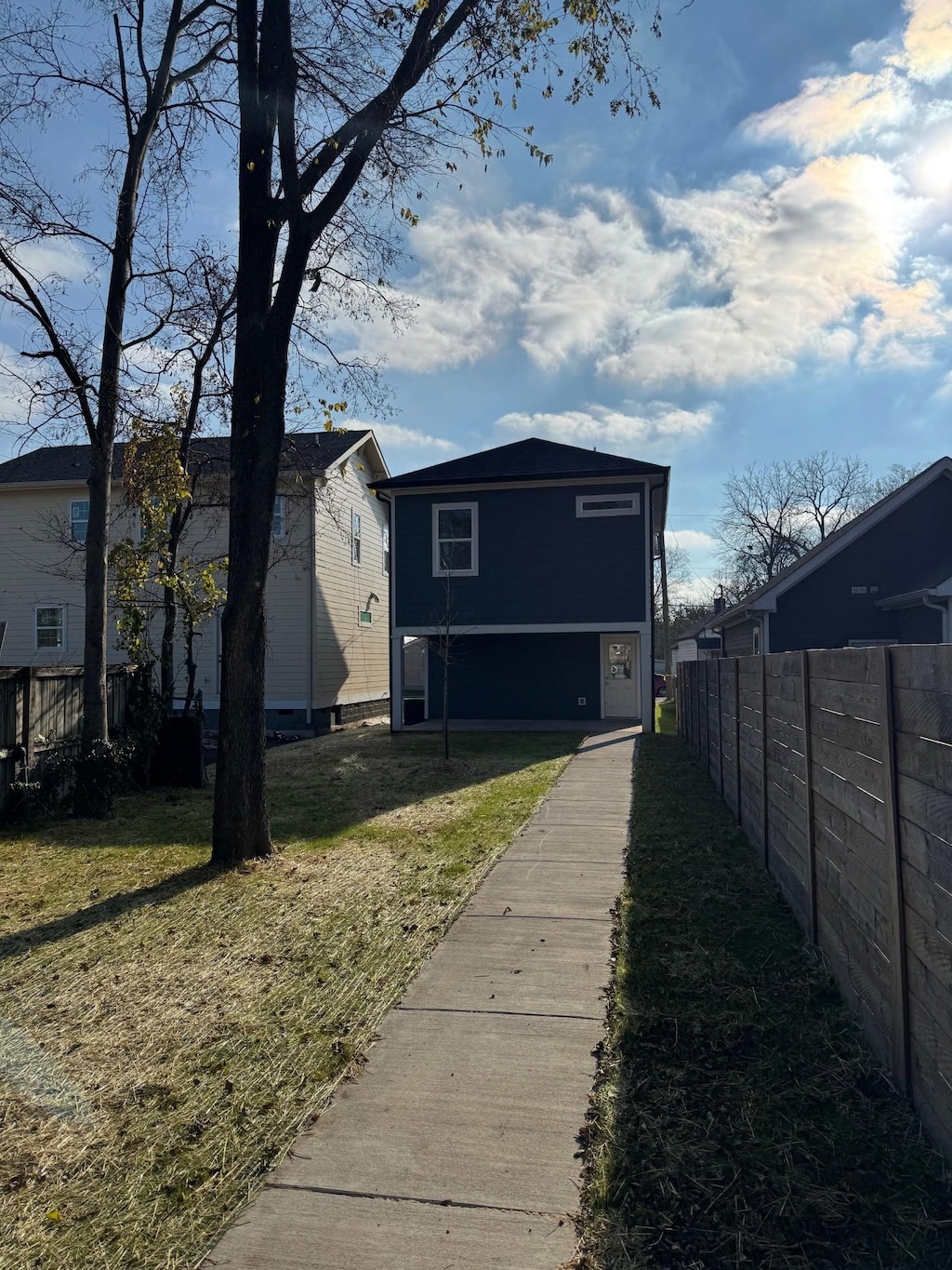 rear view of property featuring a lawn