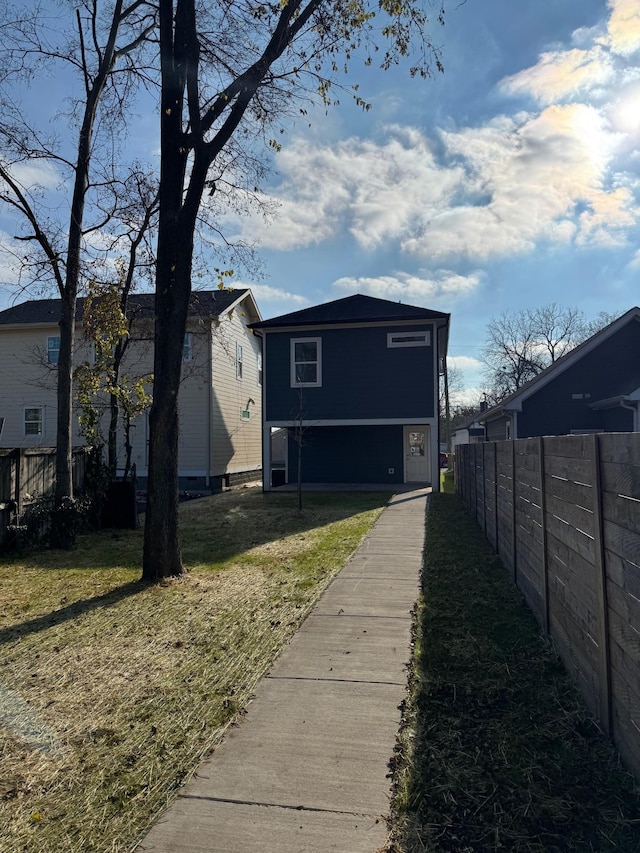 rear view of property featuring a lawn