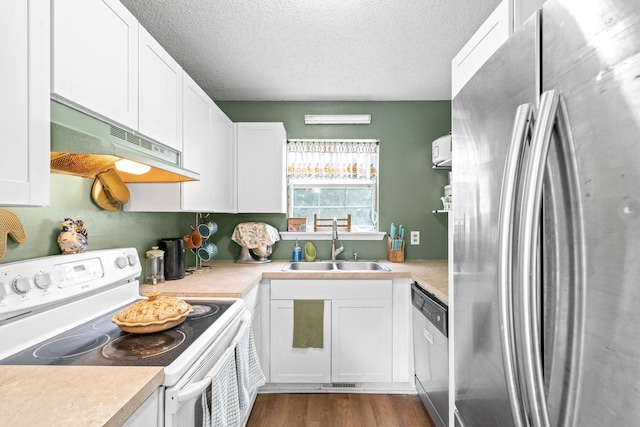 kitchen with white cabinets, extractor fan, a textured ceiling, and appliances with stainless steel finishes