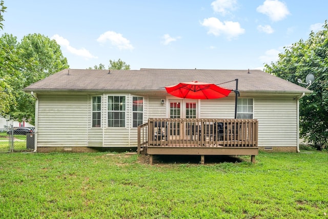 rear view of property featuring a yard and a deck