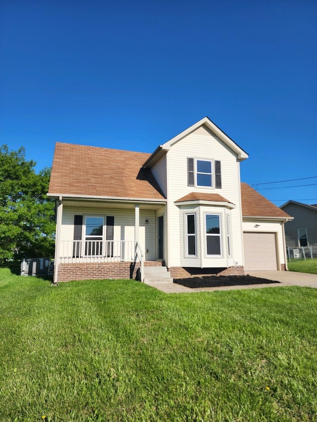 view of front of property featuring a porch, a garage, and a front lawn