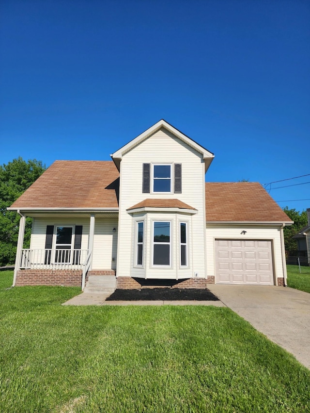 front facade featuring covered porch, a front yard, and a garage