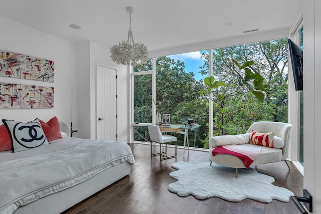 bedroom with a chandelier and dark hardwood / wood-style floors