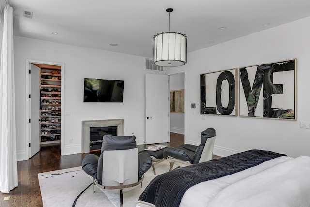 bedroom featuring dark hardwood / wood-style floors, a spacious closet, and a closet