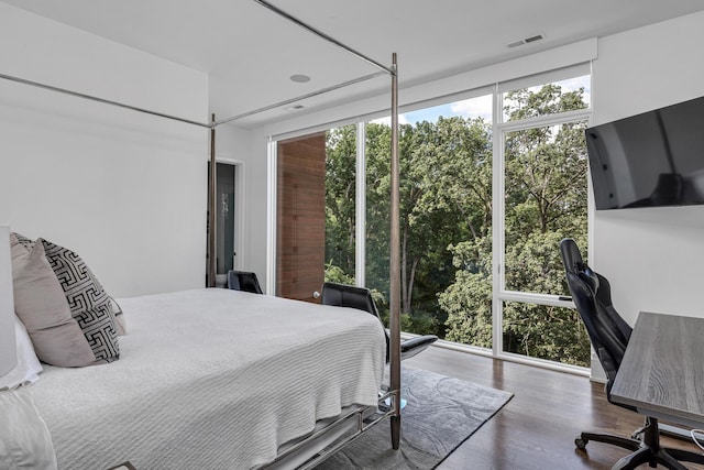 bedroom with dark hardwood / wood-style flooring