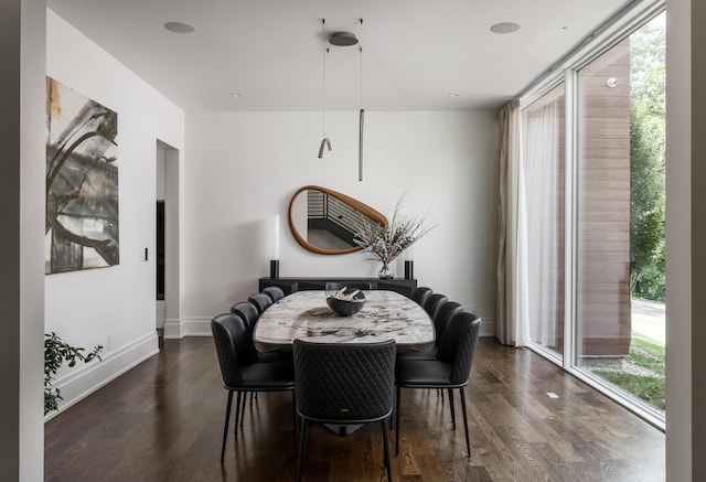 dining area featuring a healthy amount of sunlight and dark wood-type flooring