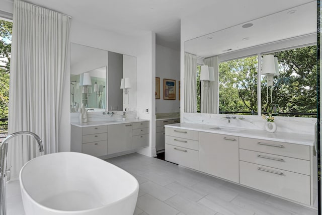 bathroom with a tub and vanity