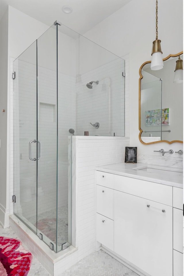 bathroom with vanity and a shower with door