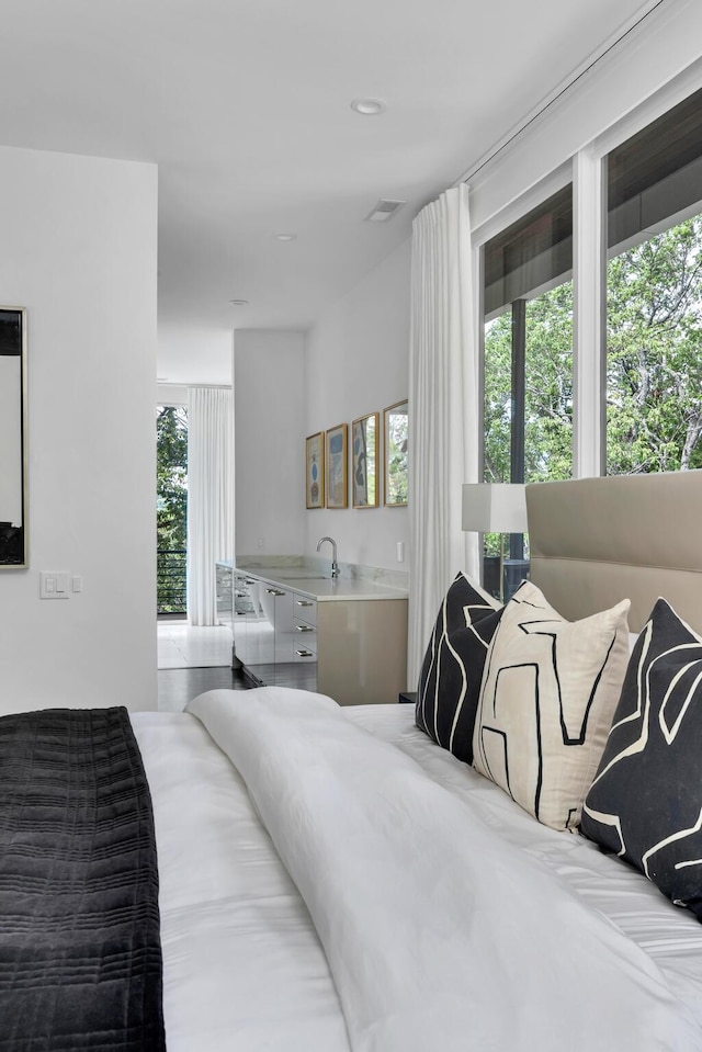 bedroom featuring sink and multiple windows