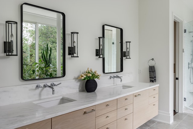 bathroom featuring tile patterned floors, a shower with door, and vanity