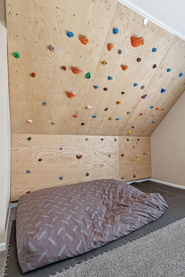 bedroom featuring vaulted ceiling and wood ceiling