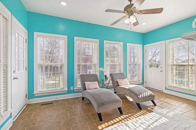 living area with visible vents, recessed lighting, a wealth of natural light, and baseboards