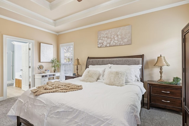 bedroom with carpet floors, a raised ceiling, ornamental molding, and ensuite bathroom