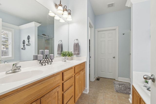 bathroom with a stall shower, tile patterned flooring, a sink, and double vanity