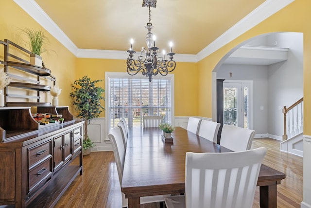 dining room featuring stairway, dark wood finished floors, and ornamental molding