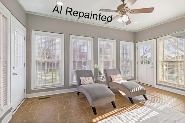 sunroom / solarium with plenty of natural light, visible vents, and a ceiling fan