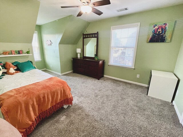 carpeted bedroom featuring baseboards, visible vents, and vaulted ceiling