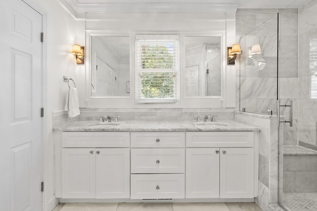 bathroom featuring tile patterned flooring, vanity, a shower with door, and ornamental molding