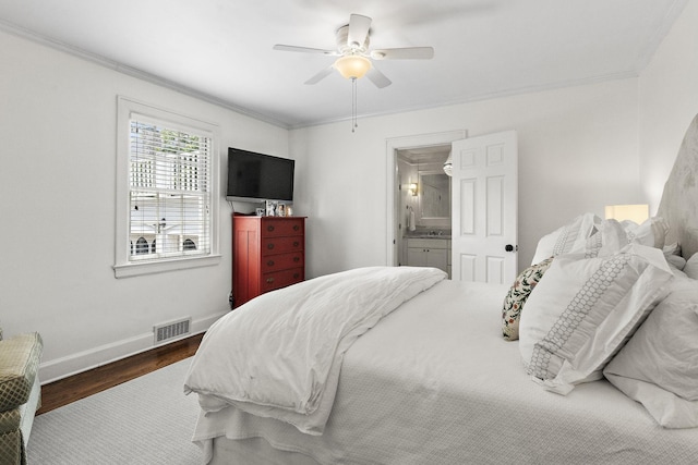 bedroom with hardwood / wood-style floors, ceiling fan, crown molding, and connected bathroom